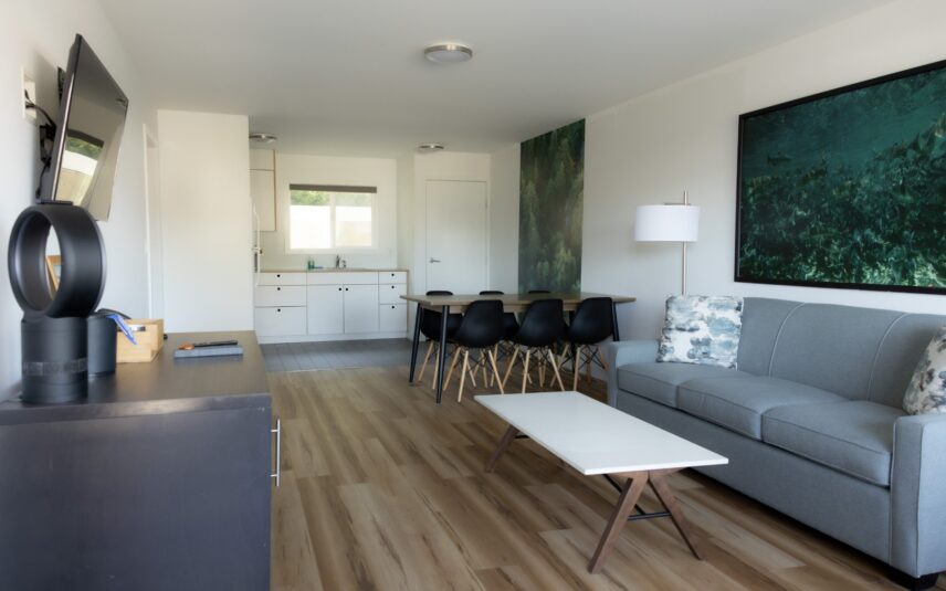 Dining table and kitchenette area in a king suite with natural wood accents