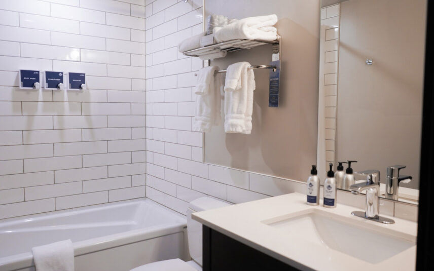 Private king suite bathroom with modern fixtures and tiled shower