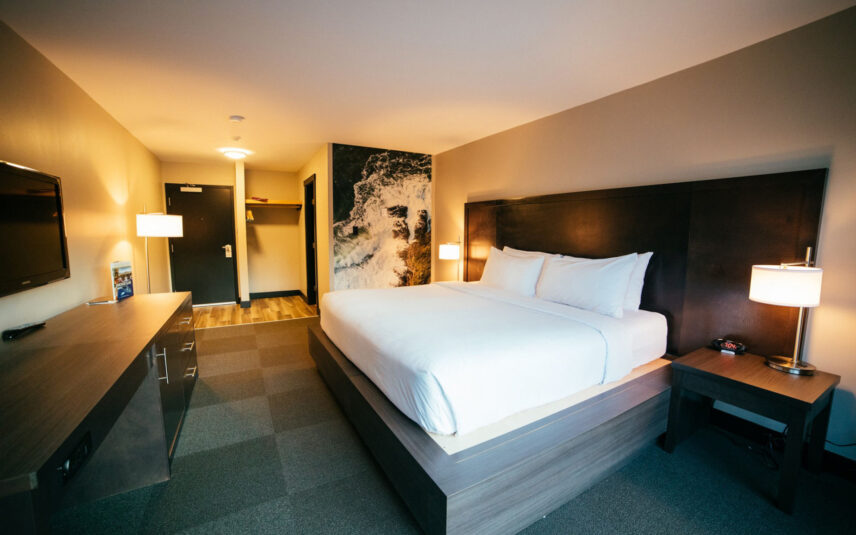 Deluxe room featuring soft lighting and west coast landscape artwork