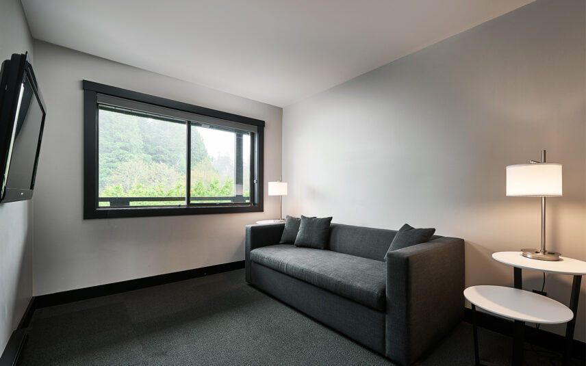 Comfortable pull-out couch in Tofino hotel suite living area