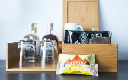 Locally curated snacks, mugs, and coffee setup in hotel suite