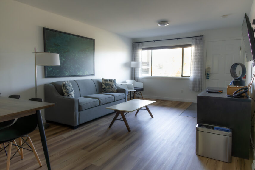 Tofino hotel room with natural hardwood floor and spacious living room area