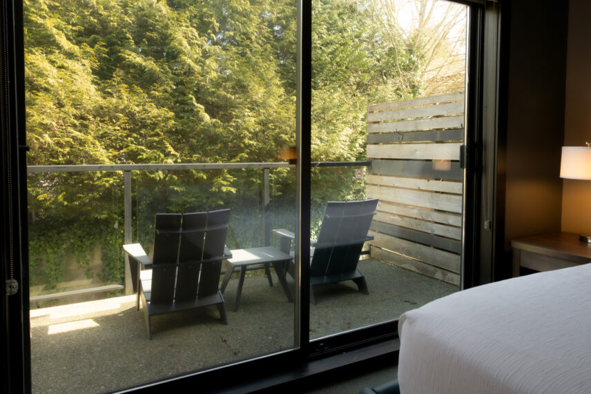 Balcony view from king room overlooking lush green forest