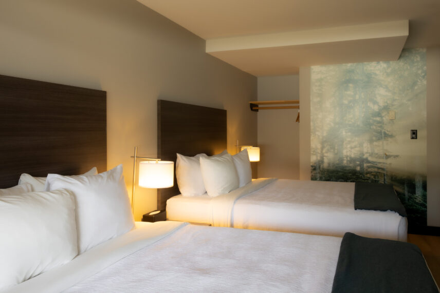Modern and coastal Tofino hotel room with 2 queen beds