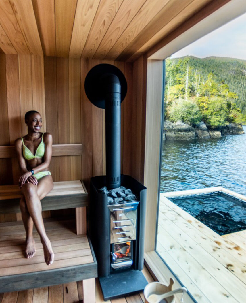 Guest relaxing in Tofino Resort + Marina’s remote floating sauna in the inlet