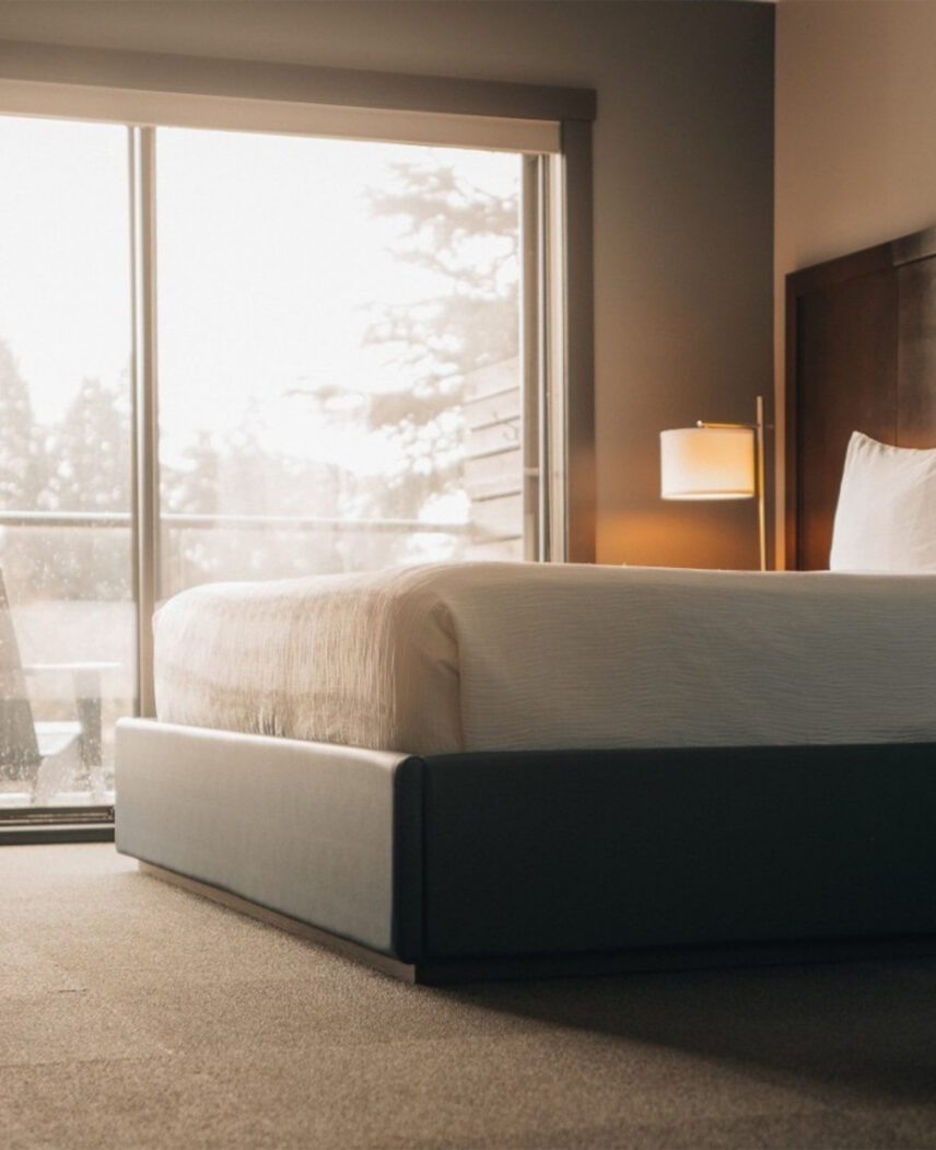 Cozy Tofino Resort + Marina hotel room with a foggy harbour view through the window