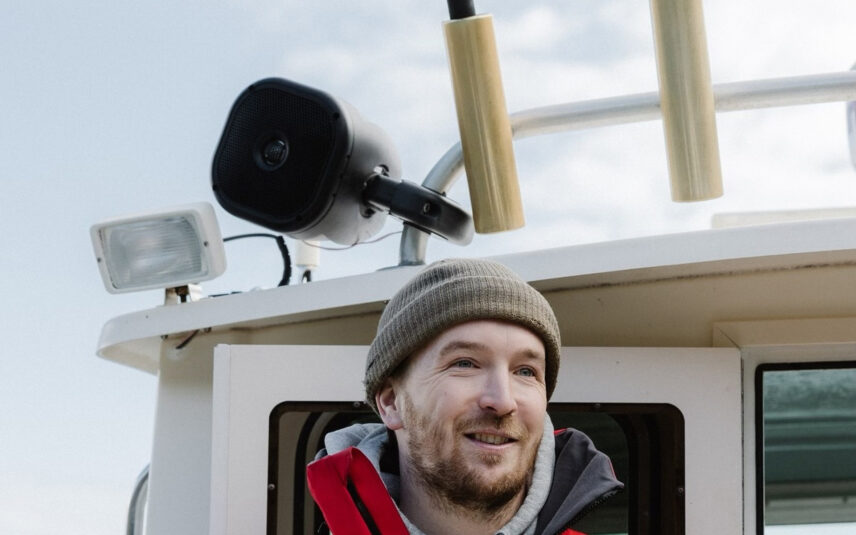 Captain Dave wearing a toque and smiling on board a boat