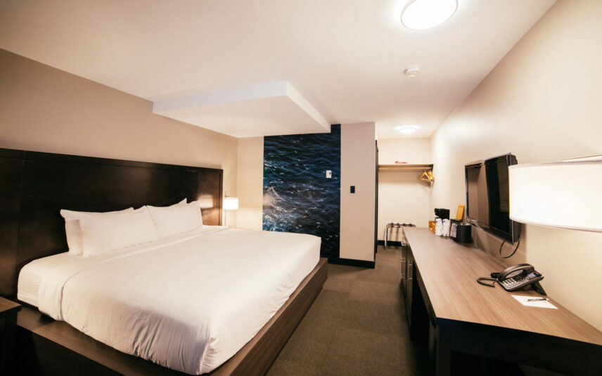 Cozy king bed in a bright, west coast inspired hotel room