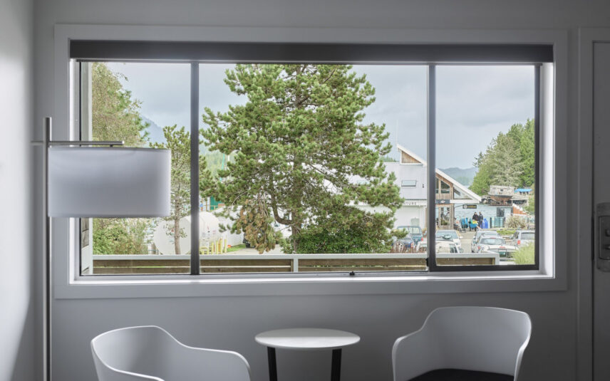View from the ground floor suite of Tofino’s harbour and towering coastal trees