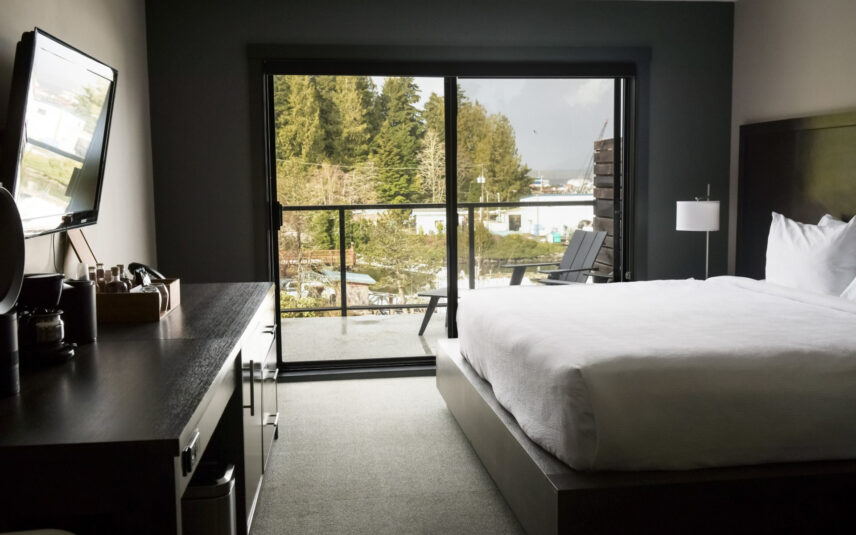 Window view from king room looking out to green forest canopy