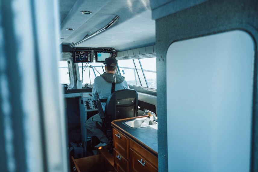 Captain Dave steering a boat through calm waters
