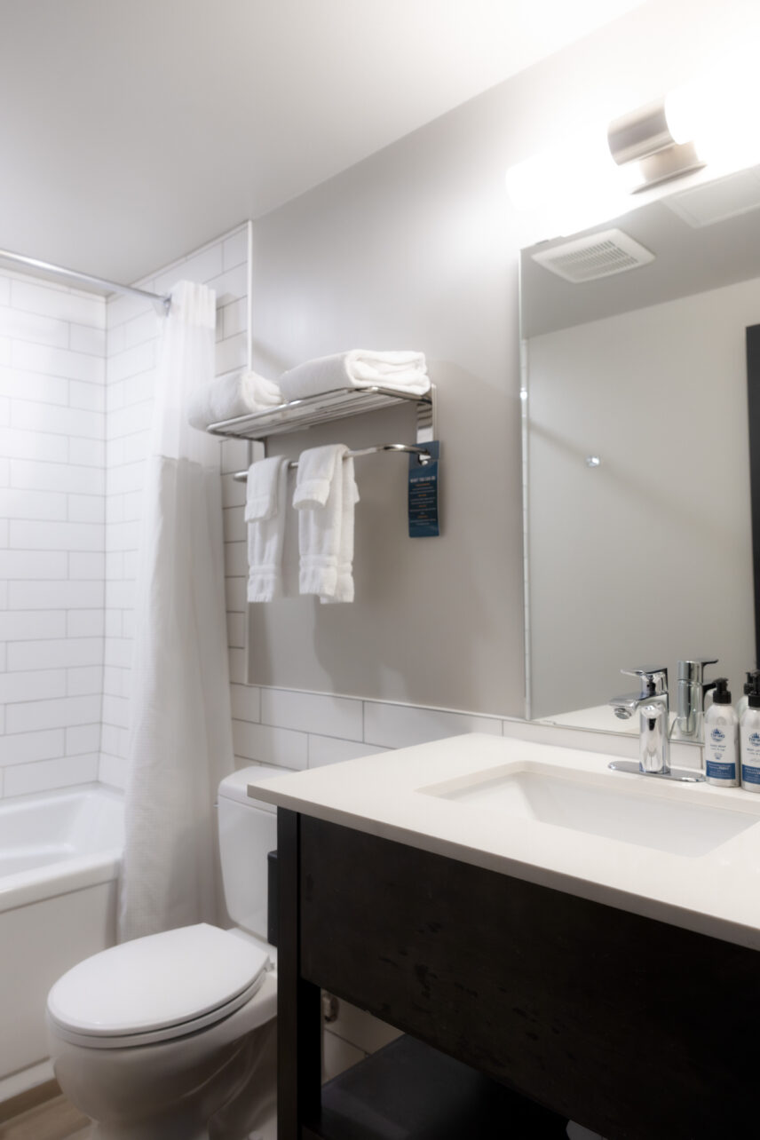 Clean modern hotel bathroom with vanity and shower