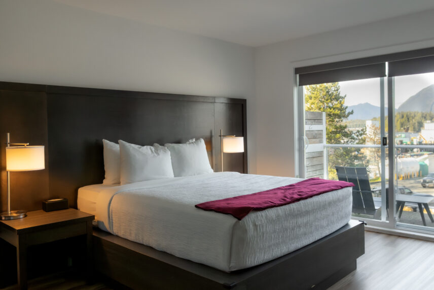 Queen suite with natural light and partial view of the harbour through wide windows