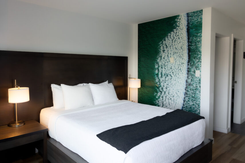 Queen suite with natural light and partial view of the harbour through wide windows