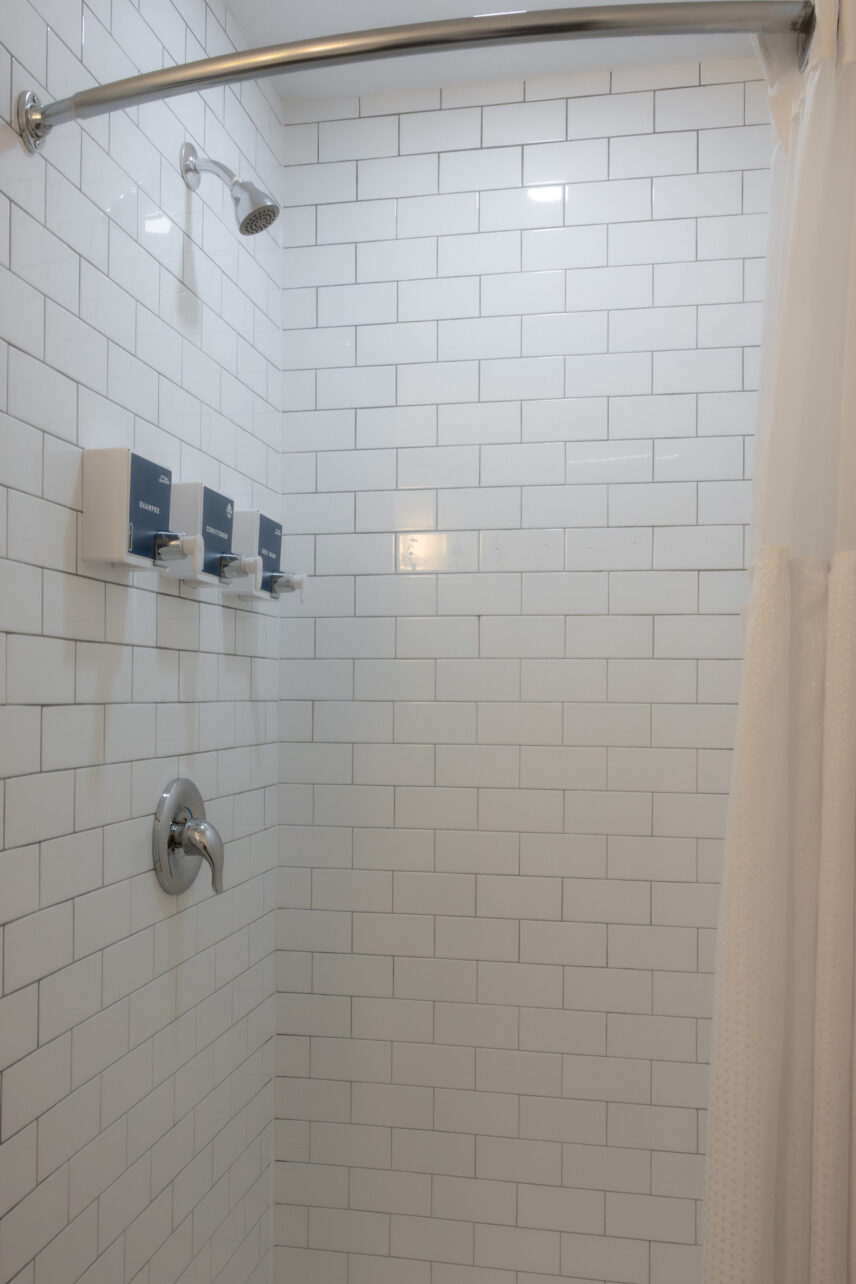 Modern bathroom with shower and sleek fixtures in queen suite