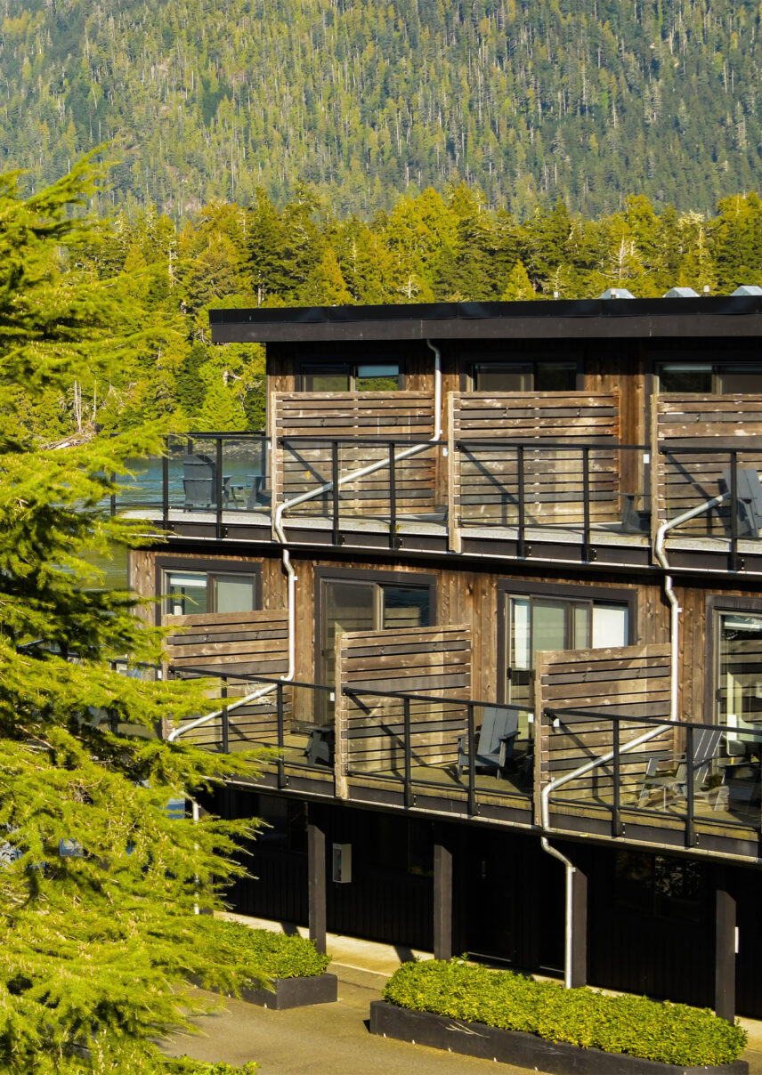 Exterior of Tofino Resort + Marina hotel nestled among west coast trees and greenery