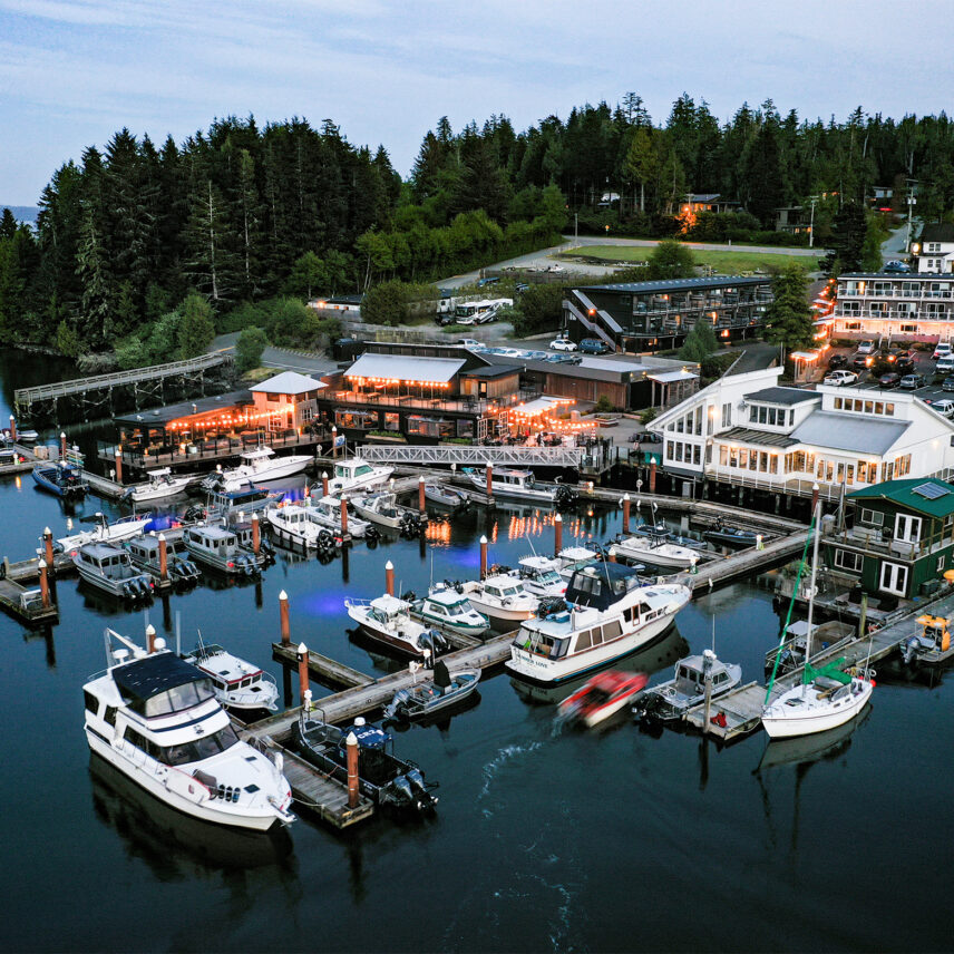 The marina with many boats docked with the Adventure Center and the resort