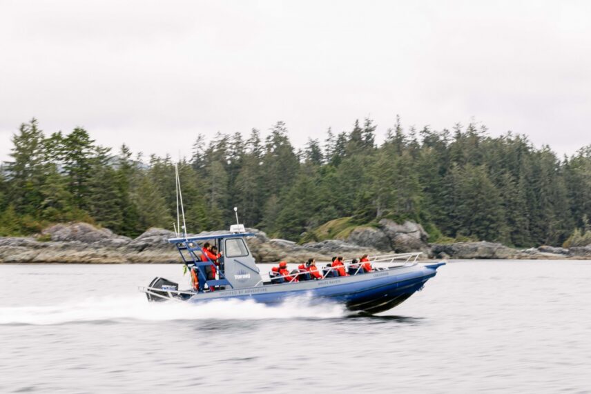 Tofino Resort + Marina’s open Zodiac with guests cruising through the water
