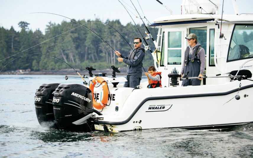 Guests fishing off the side of a boat in the calm waters of Clayoquot Sound