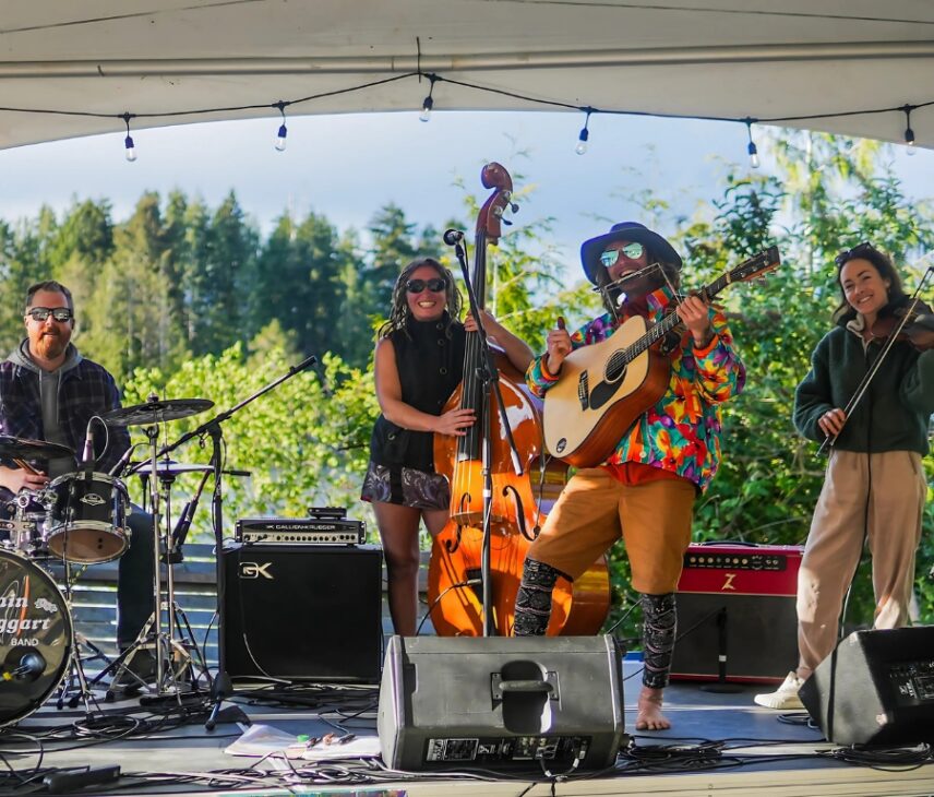 A band performing live with smiles and energy, creating a fun and lively atmosphere
