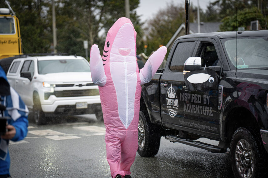 Person in shark suit by a TRM truck during the Whale Fest parade